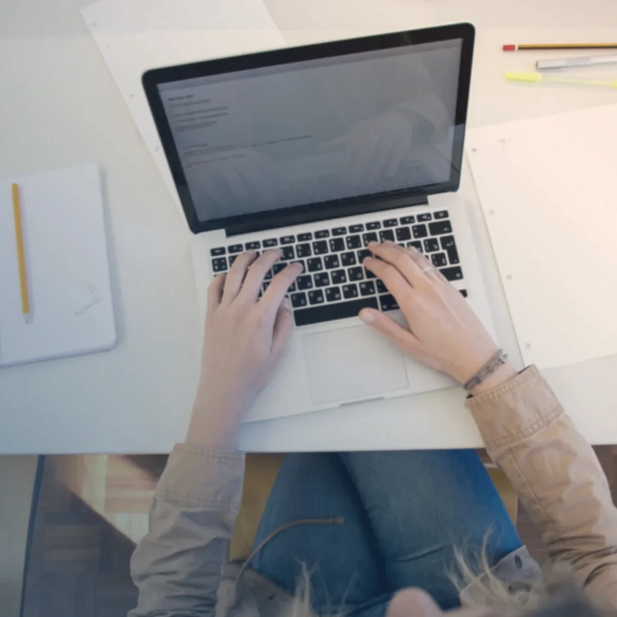 A person working through documents at a laptop.
